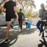 man in black t-shirt and black shorts running on road during daytime